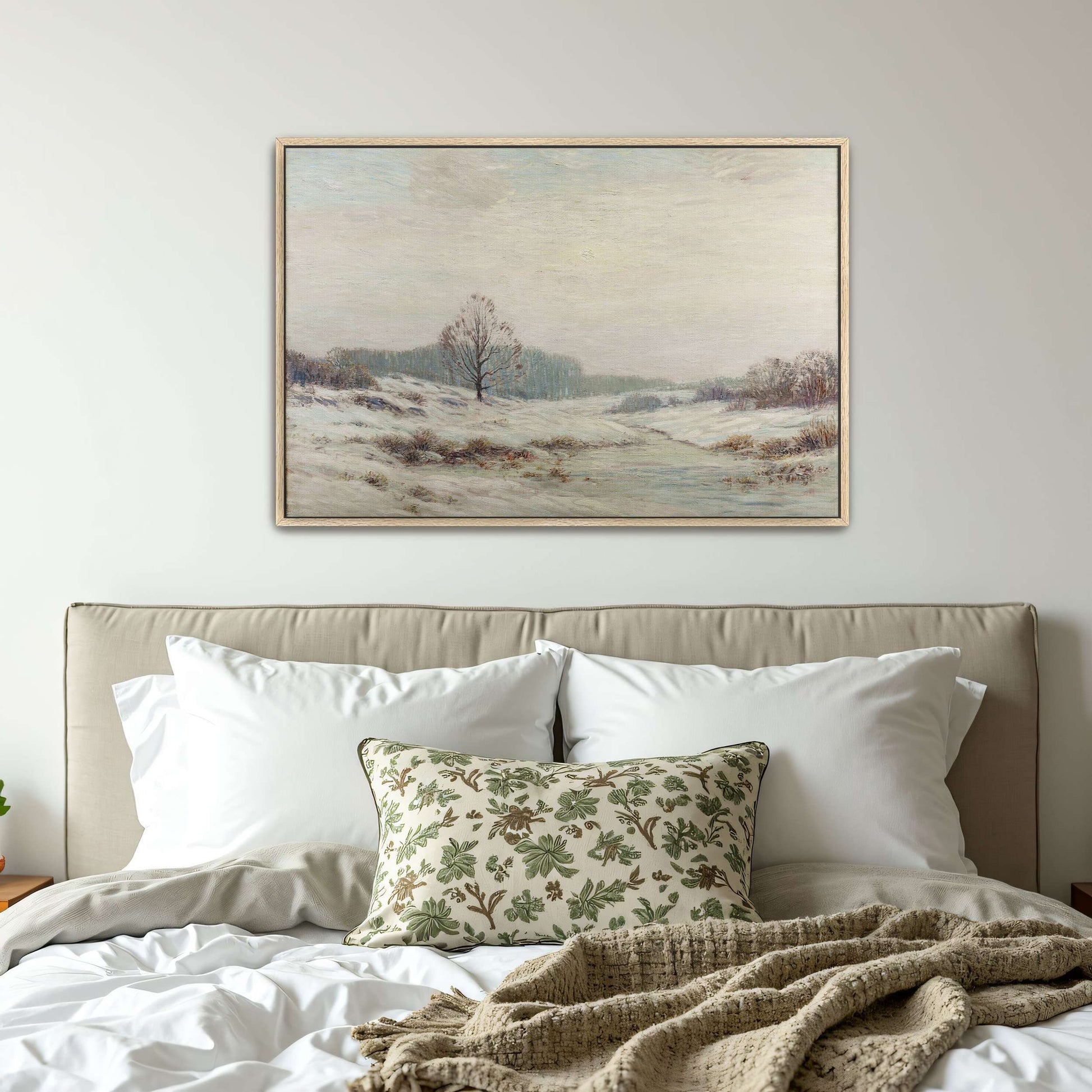 Snowy winter landscape with a lone tree by Leonard Ochtman