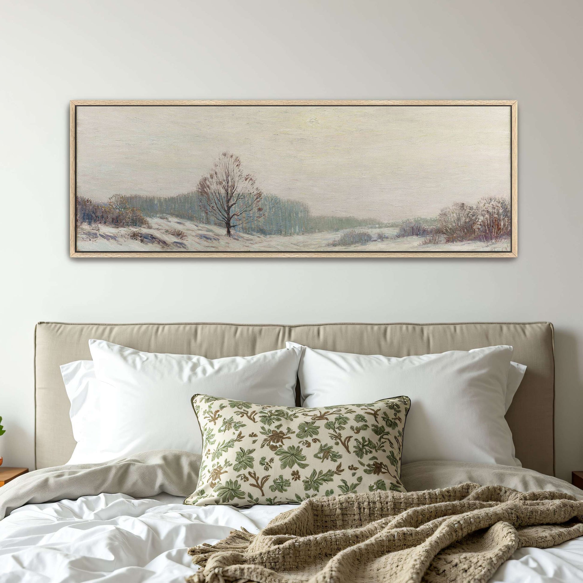 Snowy winter landscape with a lone tree by Leonard Ochtman